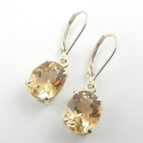 Gold leverback earrings dangle with oval citrines for a custom design.