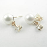 White pearls with a diamond dangle are a classic combination for these 14 kt yellow gold custom design stud earrings.