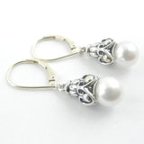 This custom jewelry features an intricate silver and gold dangle with akoya white pearls on gold leaverback earrings.
