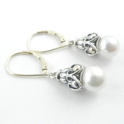 This custom jewelry features an intricate silver and gold dangle with akoya white pearls on gold leaverback earrings.