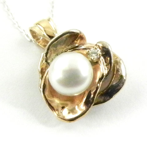 Custom design pearl pendant featuring 14k gold and silver 'puddles' and a twinkling diamond.