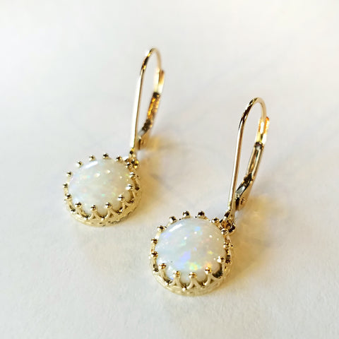 White opal cabochons dangle like mysterious moons in custom design crown mold gold leverback earrings.  