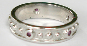 14kt white gold band with bezel set Rubies