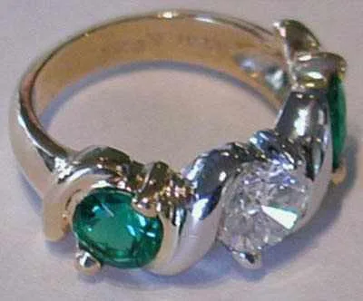 ER-1 — Ct center emerald and two .80 ct side diamonds