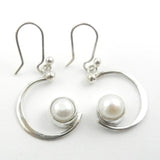 Custom made silver dangle earrings with a silver crescent and a white pearl like a full moon.