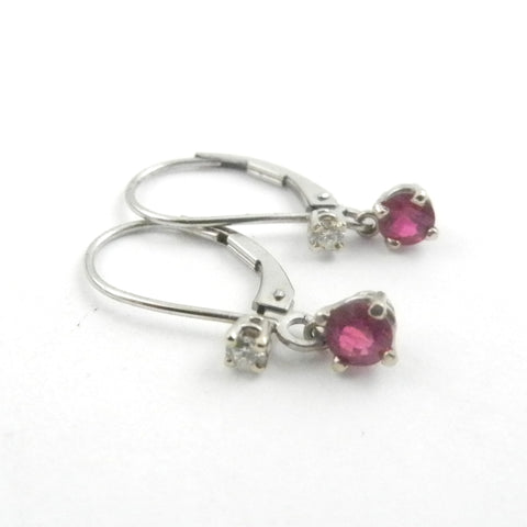 Rubies set in white gold dangle earrings with a leverback are accented with diamonds.