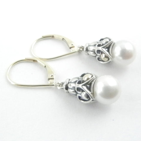 This custom jewelry features an intricate silver and gold dangle with akoya white pearls on gold leaverback earrings. 