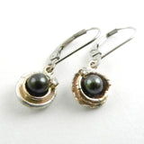 Leverback earrings with tahitian pearls surrounded by an orbit of silver and gold and a twinkling diamond
