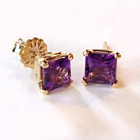 Elevate your outfit with these gold stud earrings custom made with princess cut amethyst and 14 kt yellow gold.