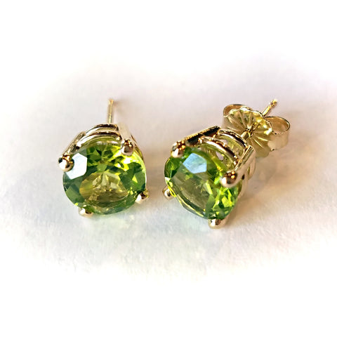 Add an elegant touch with these custom design gold stud earrings set with round peridot stones.