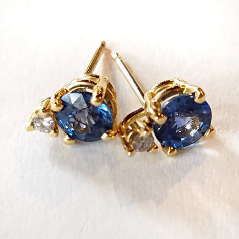 Indulgent round sapphires with diamond accents set in custom design gold stud earrings.