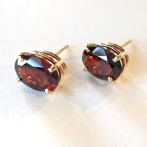 Oval garnets set in custom made gold stud earrings. 